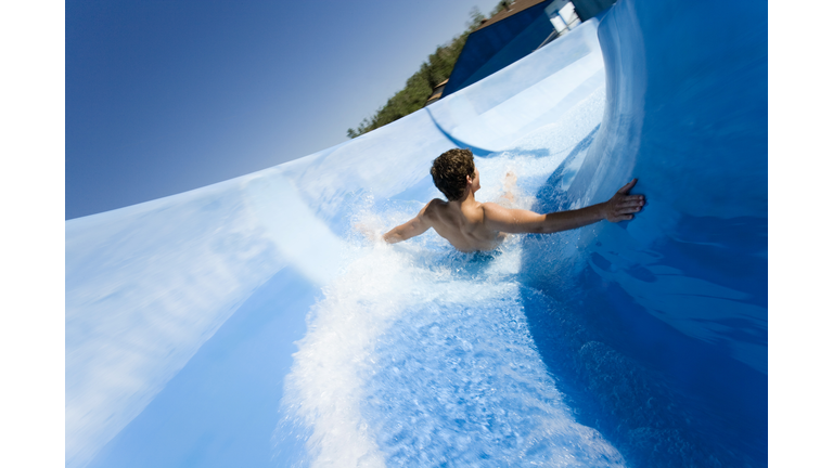 Man going down water slide