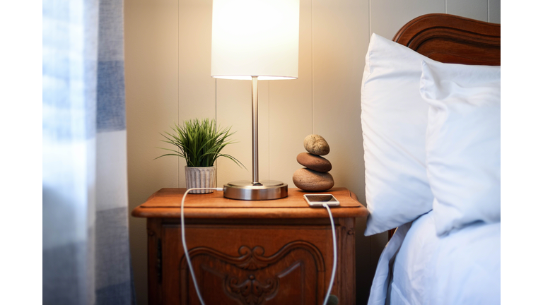 Smartphone charging on the nightstand - mixed modern and vintage design