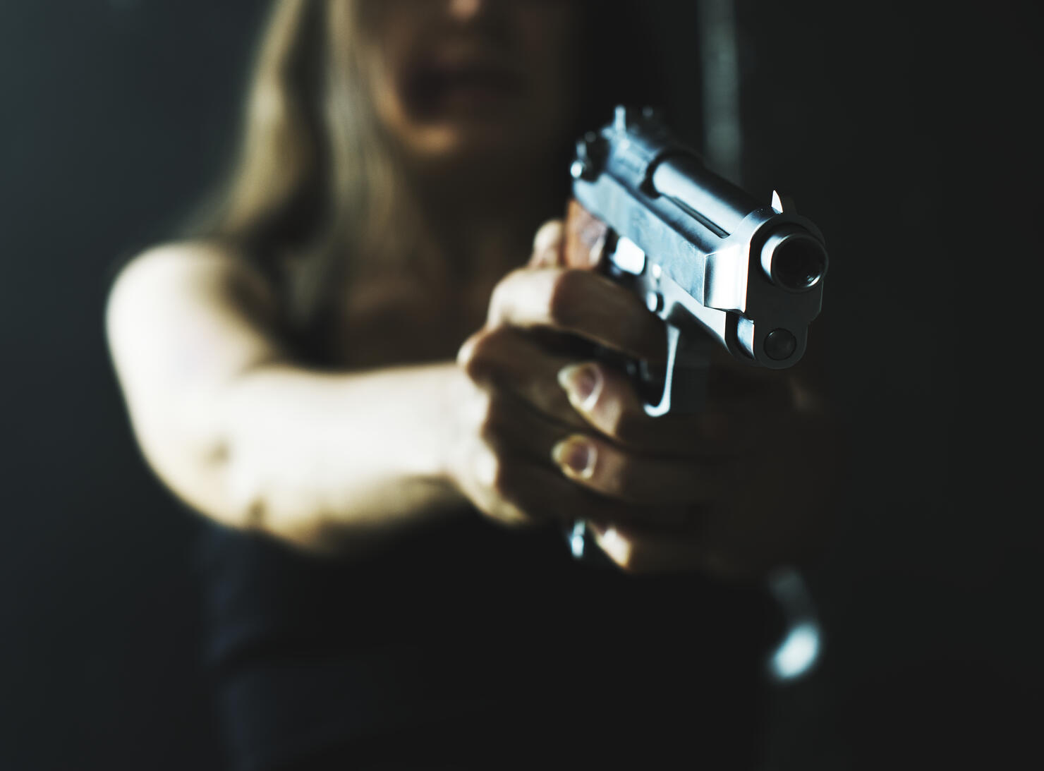 Woman shooting weapon