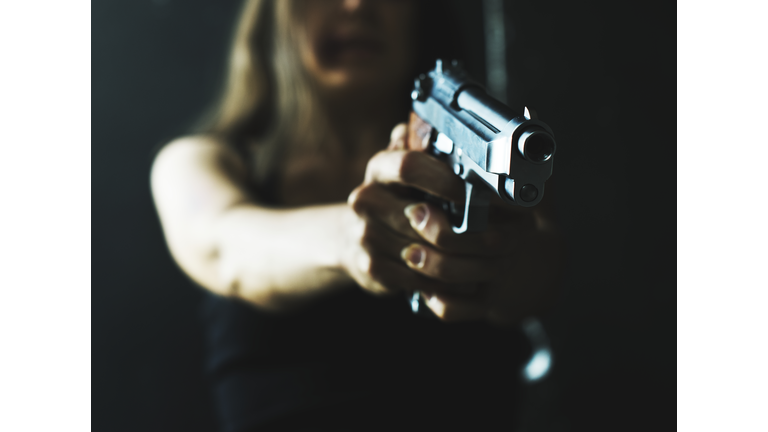 Woman shooting weapon