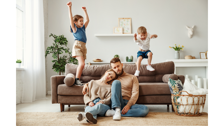 Tired parents spending day at home with kids