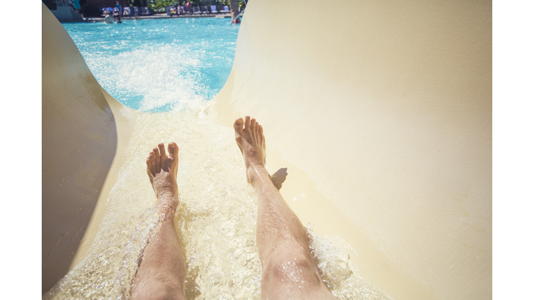 Riding down a slide at a waterpark resort