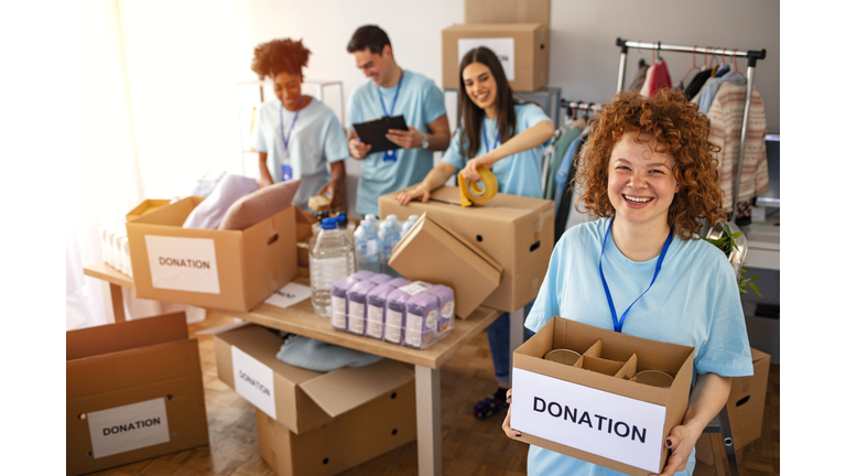 Volunteers Collecting Food Donations In Warehouse.