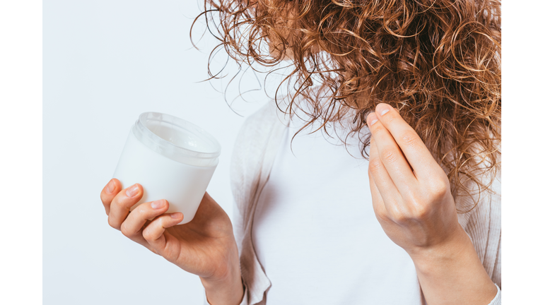 Female's hands apply cosmetic coconut oil