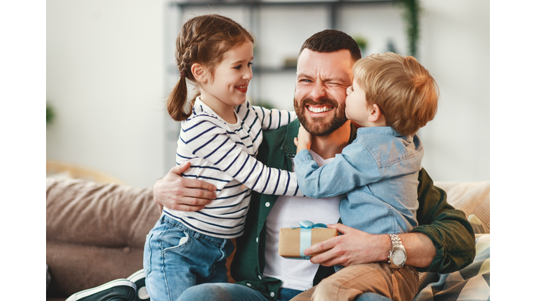 Happy father getting congratulations from kids