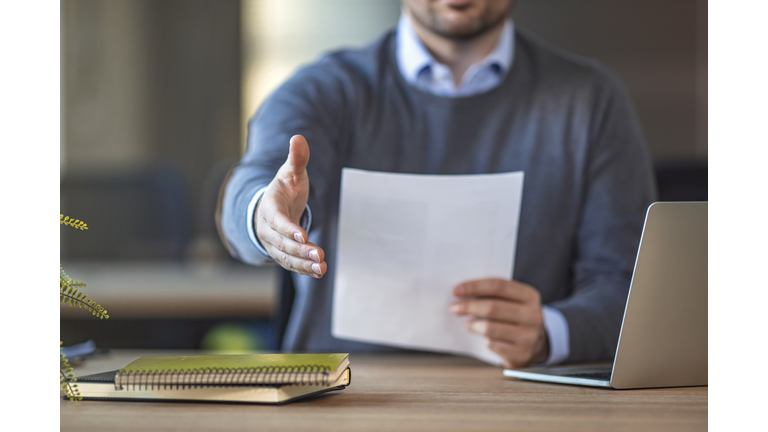 Businessman with an open hand ready for handshake
