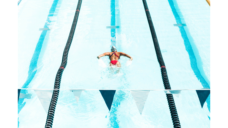Athlete swimming in olympic pool