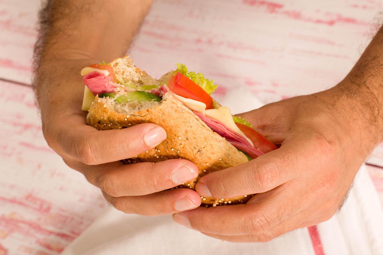 close-up a man holding a sandwich