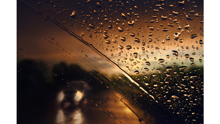Blurry Windshield With Water Drops From the Rain in Traffic