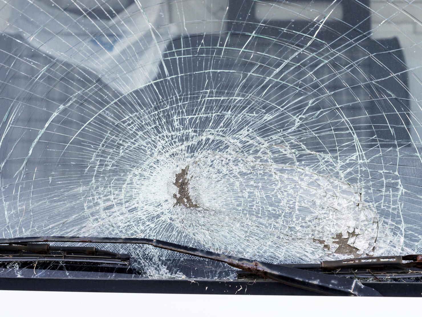Shattered windshield after car crash. Vehicle accident. Broken glass.