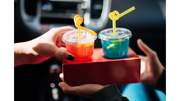 Driver and passenger drinking in the car