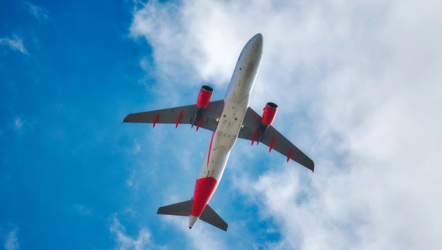 Underbelly of a jet airplane flying in the air