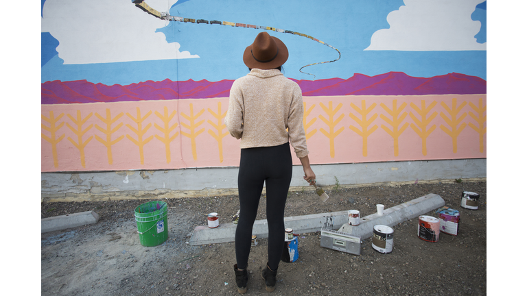 Artist admiring mural wall