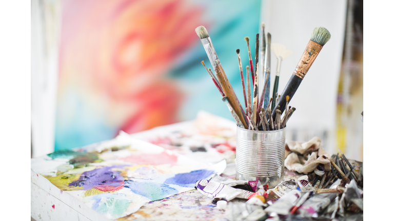 Paints and paint brushes in an artists studio