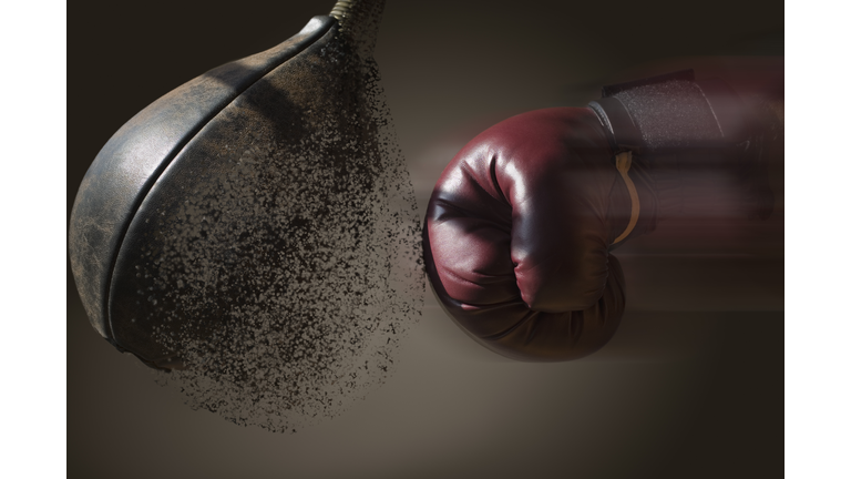 Close up boxer and punch bag with blurred motion