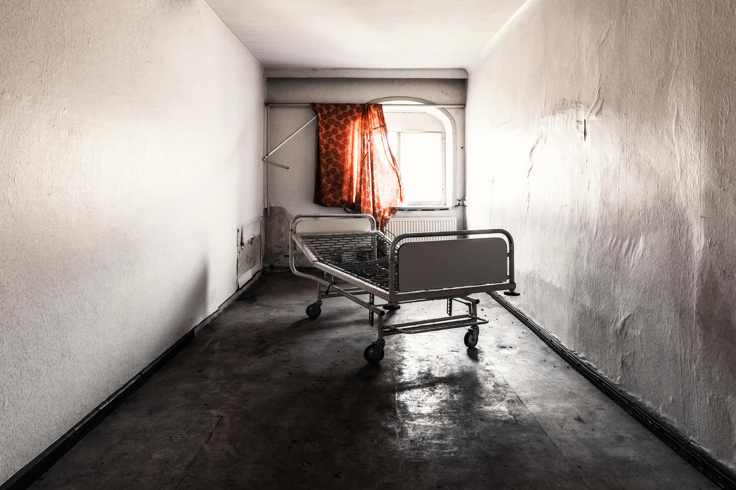 One old bed in a room in an abandoned hospital