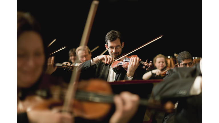 Violin players in orchestra