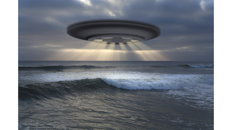 View of the flying saucer (UFO) over the ocean.