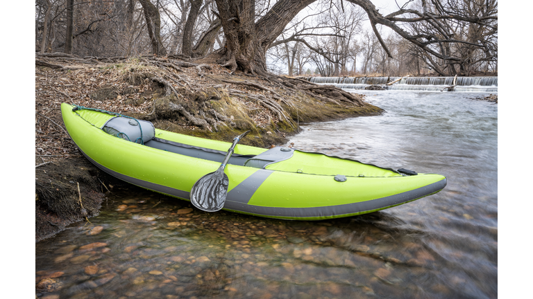 whitewater inflatable kayak on a river