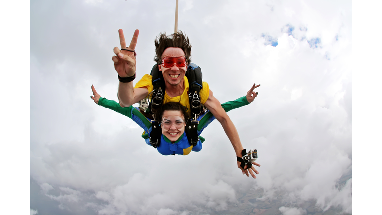 Skydiving tandem happiness on a cloudy day