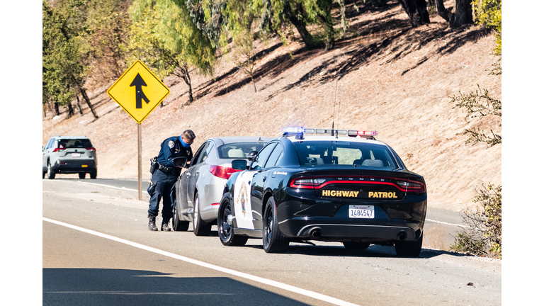 Highway Patrol officer writing a traffic ticket