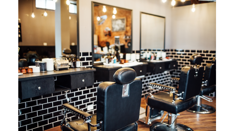 Empty black chairs and mirrors in barber shop
