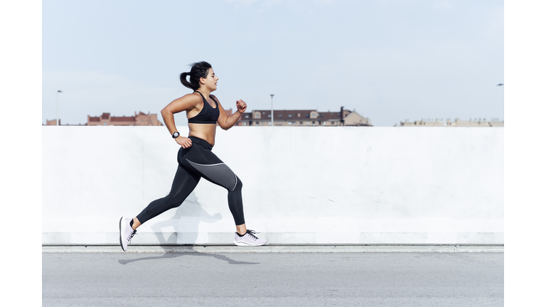 Young woman running training in the city