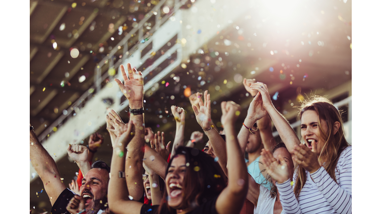 Football fans celebrating a victory in stadium