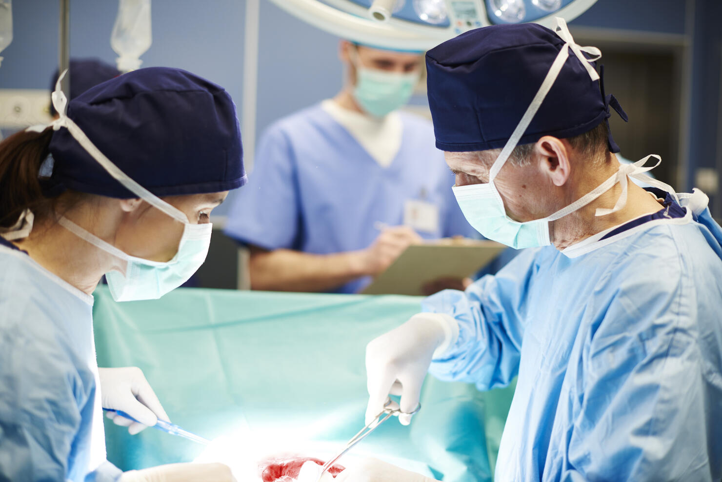 Busy surgeons over the operating table