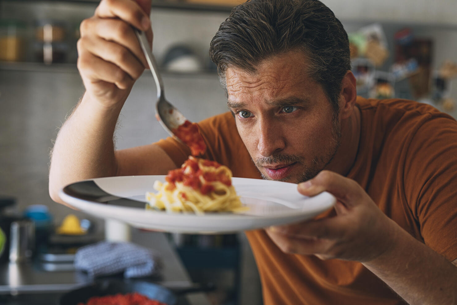 Handsome Young Caucasian Man Making Classic Tagliatelle in a Kitchen