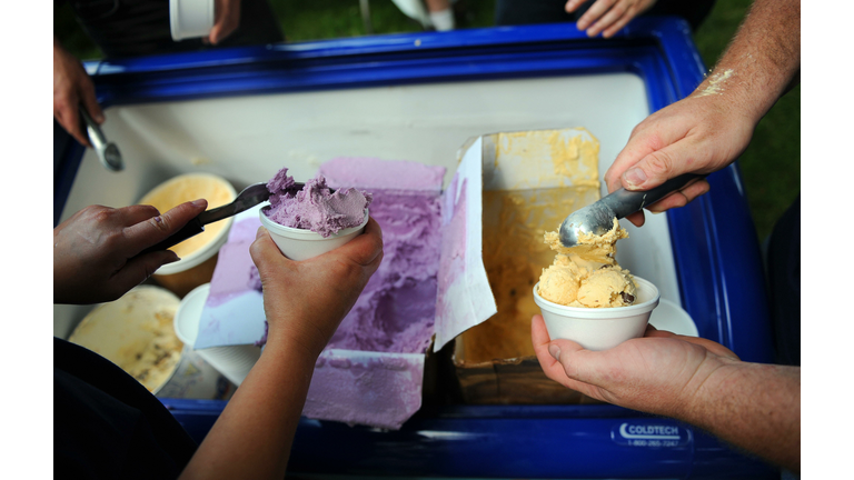 Volunteers scoop ice cream for free sund