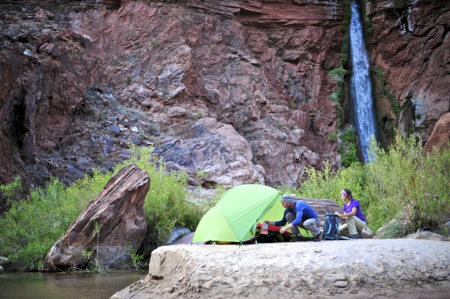 Hikers setup camp on a beach along the Colorado River near the plumeting 180-foot Deer Creek Falls in the Grand Canyon outside of Fredonia, Arizona November 2011.