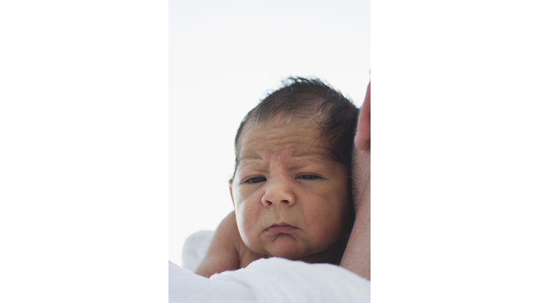 Sleepy baby in father's arms