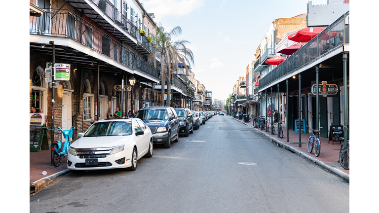 Old town Decatur street in Louisiana city with cars parked during evening