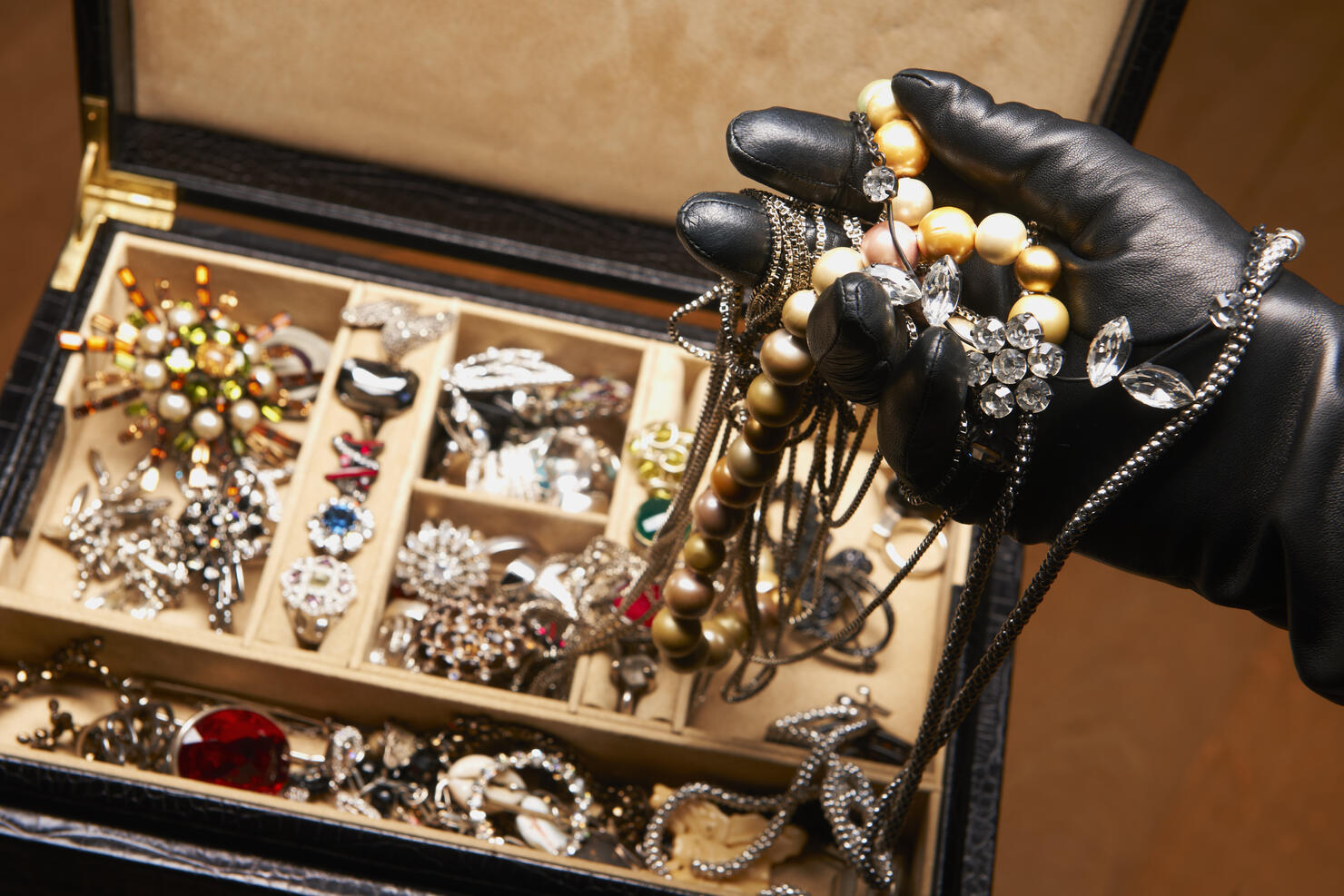 Gloved hand stealing jewelry