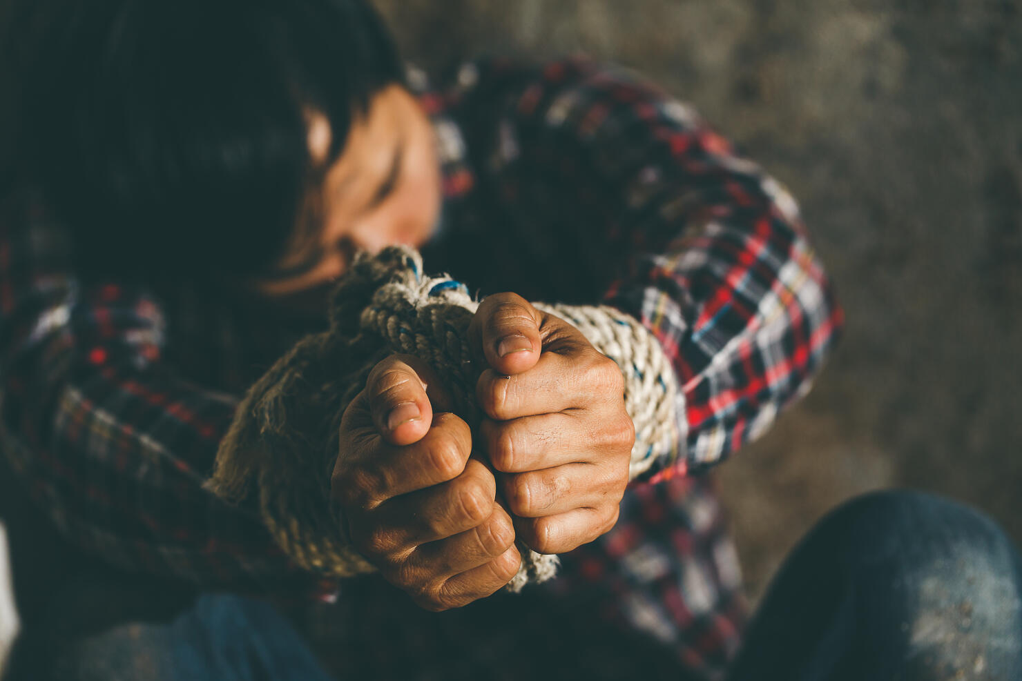 Helpless young man hands tied with rope, Missing kidnapped, Hostage, human trafficking and violence concept