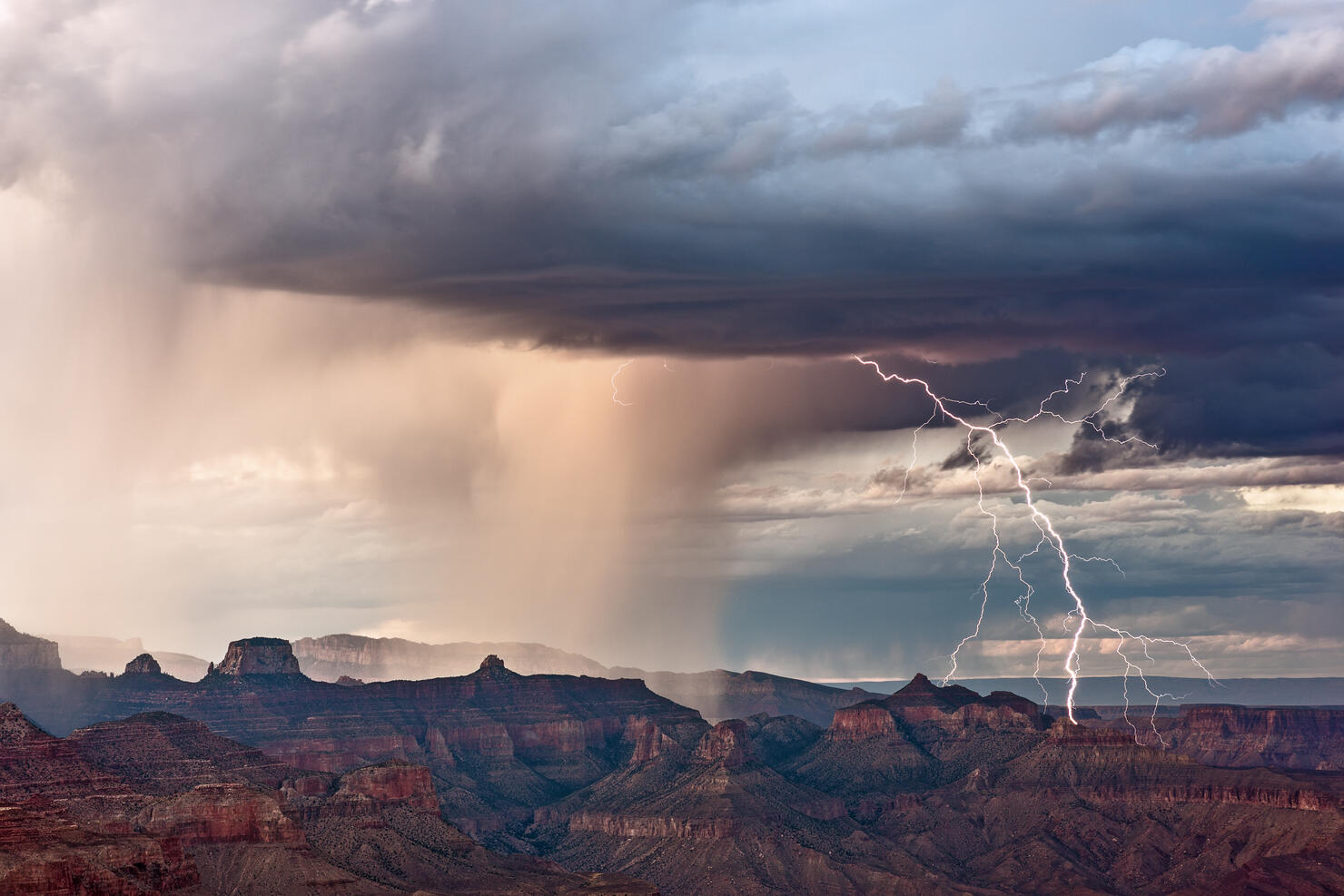 View Of Rock Formations On Landscape Against Cloudy Sky