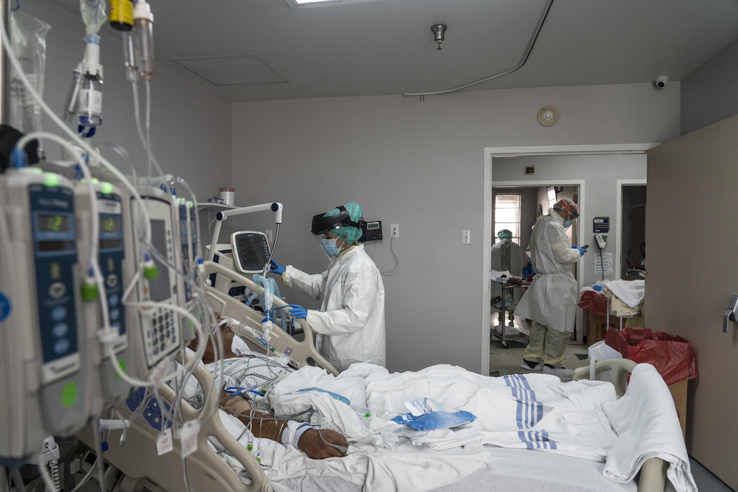  A member of the medical staff wearing full PPE treats a patient in the Covid-19 intensive care unit at the United Memorial Medical Cente in Houston, Texas. 