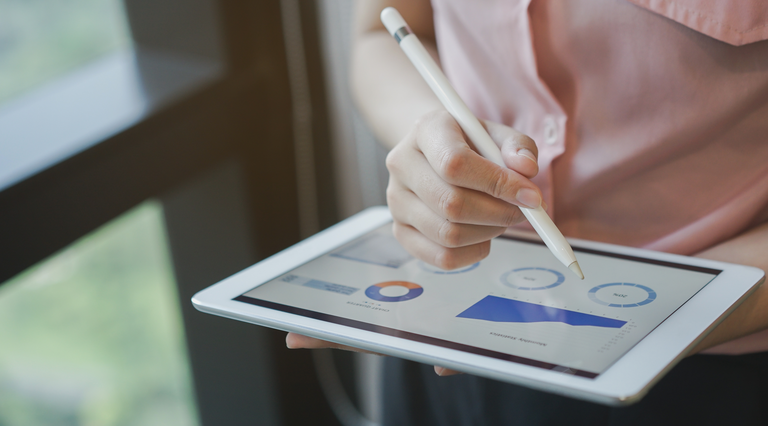 close up on businesswoman manager hand using stylus pen for writing or comment on screen dashboard tablet in meeting situation about company's performance , technology and business strategy concept