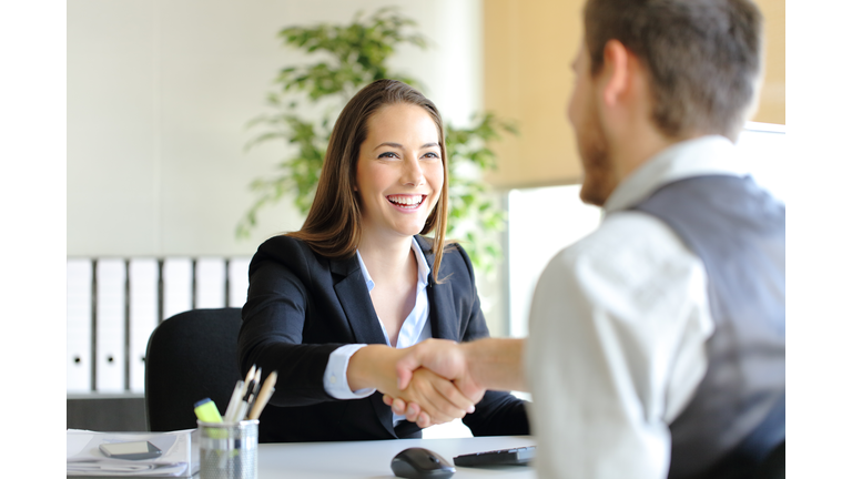 Businesspeople handshaking after deal or interview