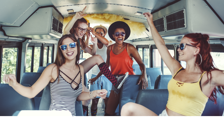 Group of young people having fun, party bus