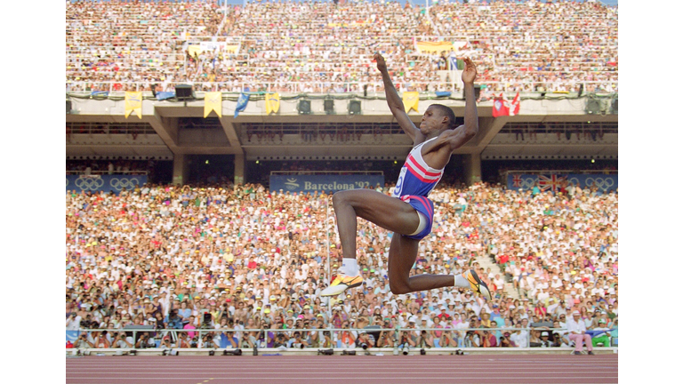 Carl Lewis of the USA flies through the air