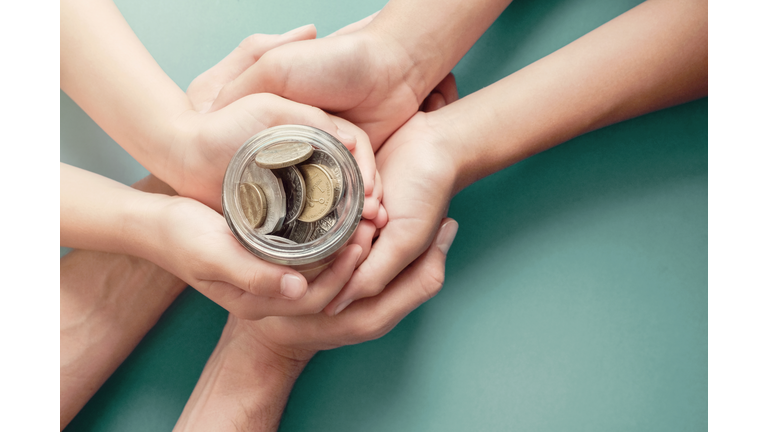 child and parent hands holding money jar, donation, saving, charity, family finance plan concept, Coronavirus economic stimulus rescue package, superannuation concept