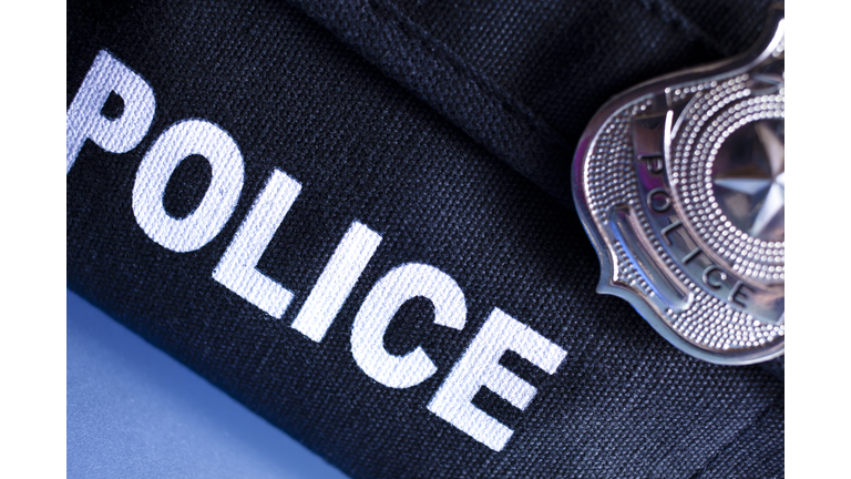 Law: Police bulletproof vest and badge.