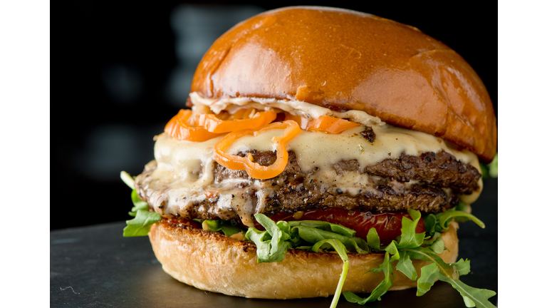 Cheese Burger, with melted swiss cheese, lettuce tomato and onions served on toasted bun