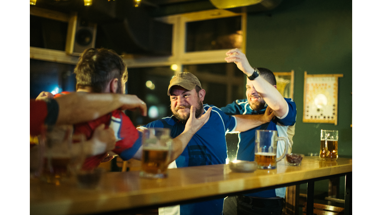 Men fighting in pub