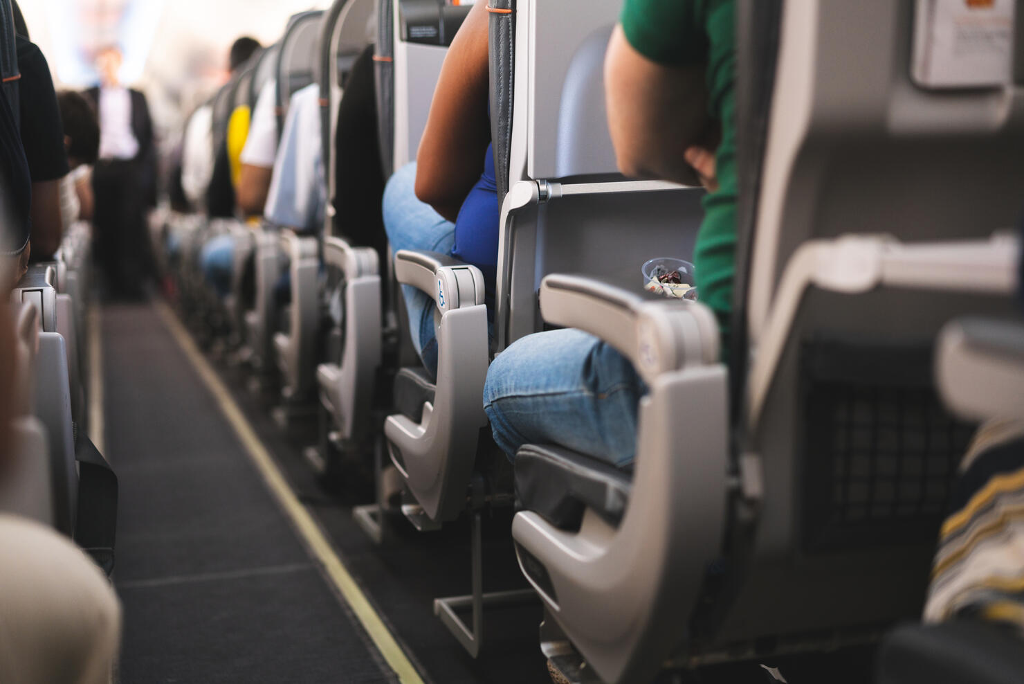 Interior of airplane with passengers on seats