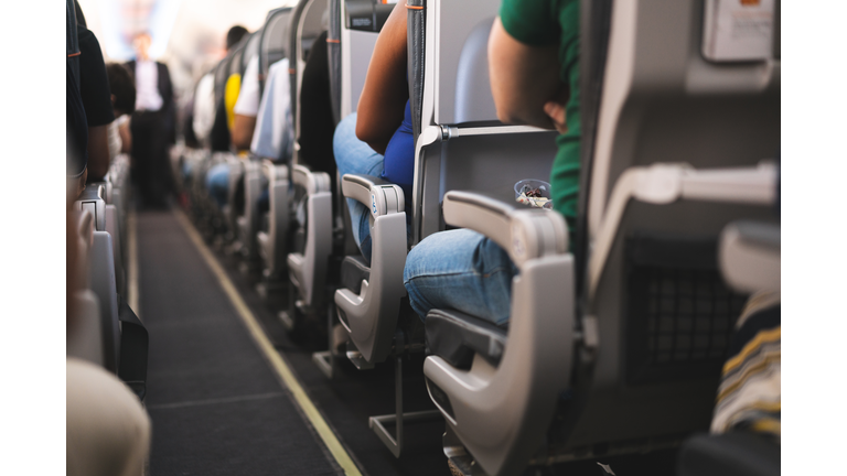 Interior of airplane with passengers on seats