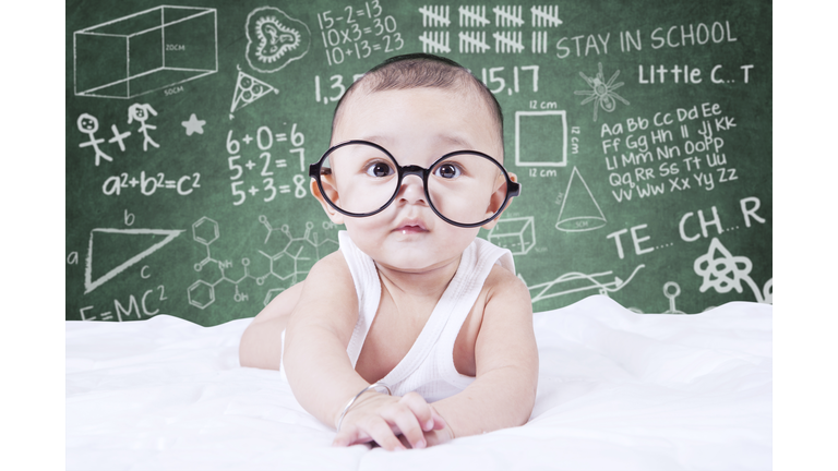 Funny baby with glasses and a doodles background