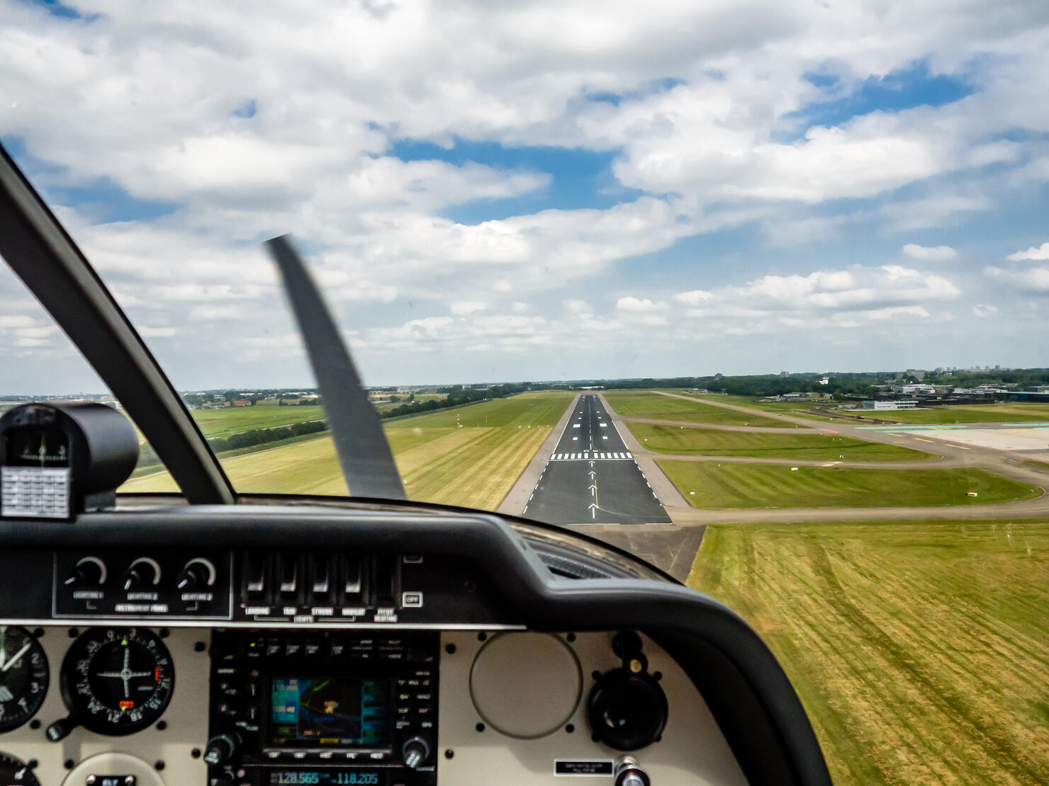 Cockpit view of a small aircraft approaching the landing runway